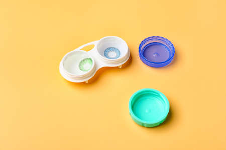 Container with contact lenses on color backgroundの写真素材