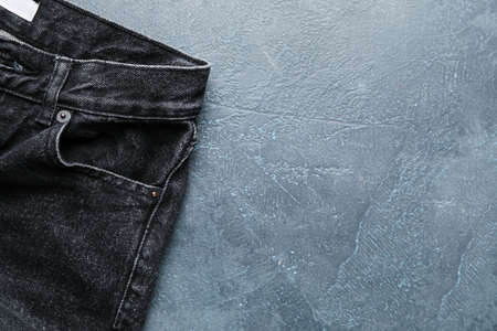 Stylish jeans pants on dark backgroundの写真素材