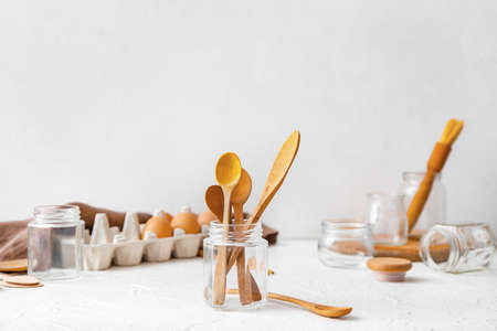 Jar with wooden cutlery on table. Ecology conceptの写真素材