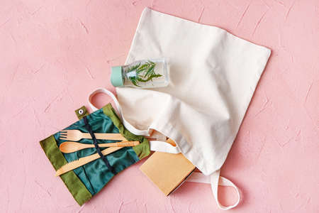 Eco containers for food and drinks with cutlery on color backgroundの写真素材