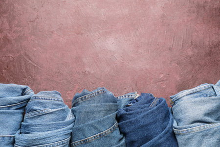 Rolled jeans pants on color backgroundの写真素材