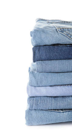 Stack of jeans pants on white backgroundの写真素材