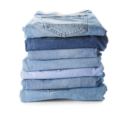 Stack of jeans pants on white backgroundの写真素材