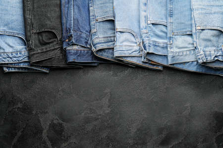 Stylish jeans pants on dark backgroundの写真素材