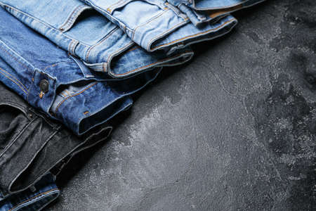 Stylish jeans pants on dark backgroundの写真素材