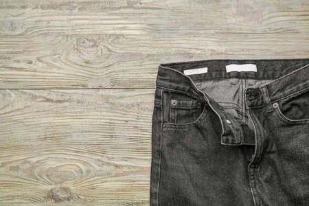 Stylish jeans pants on wooden backgroundの写真素材