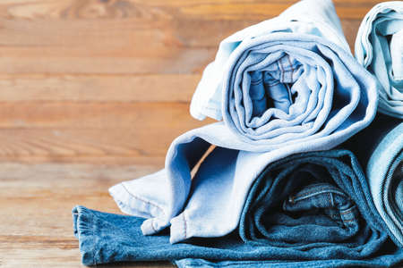 Rolled jeans pants on tableの写真素材