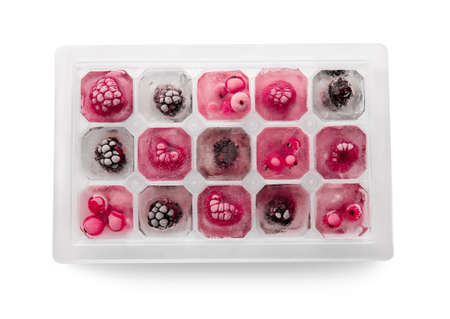 Tray with berries in ice on white backgroundの写真素材