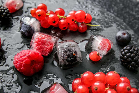 Ice with frozen berries on dark backgroundの写真素材
