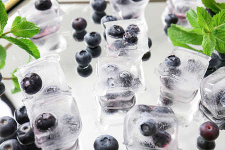 Ice with frozen berries on tray, closeupの写真素材