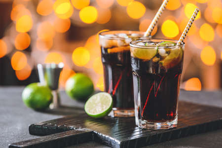 Glasses of tasty Cuba Libre cocktail on tableの写真素材