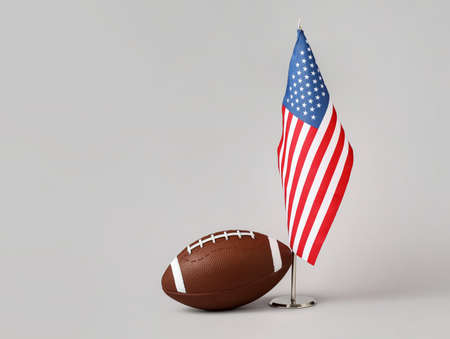 Rugby ball with national flag of USA on light background