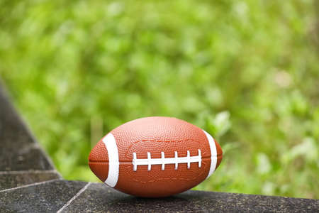 Rugby ball on parapet outdoorsの写真素材