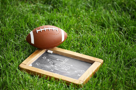 Rugby ball with scheme of football game outdoorsの写真素材