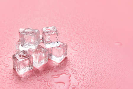 Ice cubes on color backgroundの写真素材