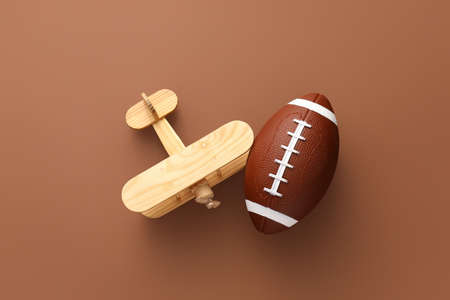 Rugby ball with toy on color backgroundの写真素材