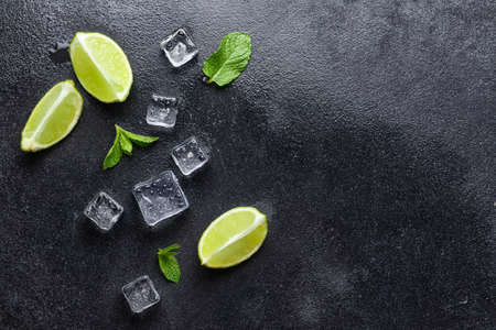 Ice cubes, lime and mint on dark backgroundの写真素材