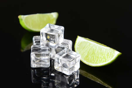 Ice cubes and lime on dark backgroundの写真素材