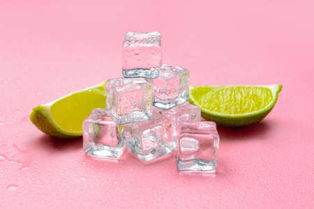 Ice cubes and lime on color backgroundの写真素材