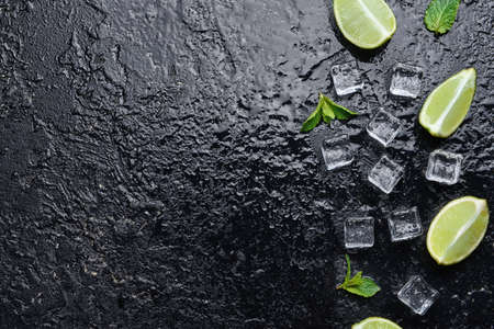 Ice cubes, lime and mint on dark backgroundの写真素材