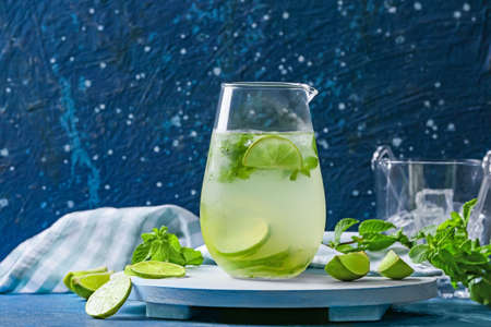 Jug of fresh mojito on table