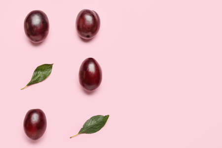 Tasty sweet plums on color backgroundの写真素材