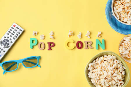 Tasty popcorn, 3D glasses and text POP CORN on color backgroundの写真素材