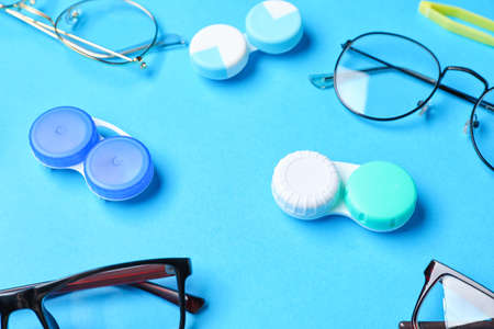 Containers with contact lenses and eyeglasses on color backgroundの写真素材