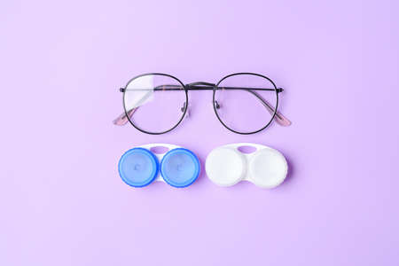 Containers with contact lenses and eyeglasses on color backgroundの写真素材