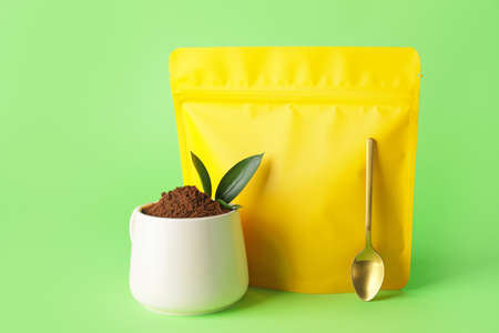 Blank coffee bag and cup on color backgroundの写真素材