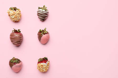 Tasty strawberry dipped in chocolate on color background