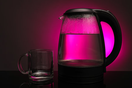 Modern electric kettle on color backgroundの写真素材