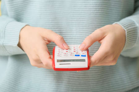 Female accountant with calculator, closeupの写真素材