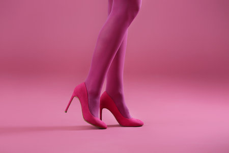 Young woman in stylish shoes on color backgroundの写真素材