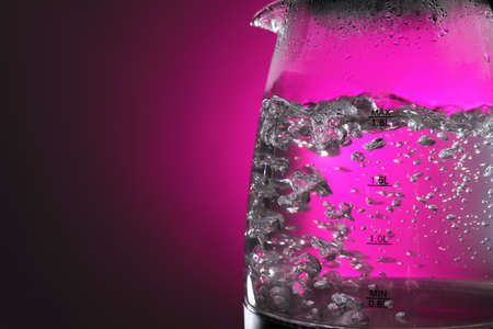 Modern electric kettle on color backgroundの写真素材