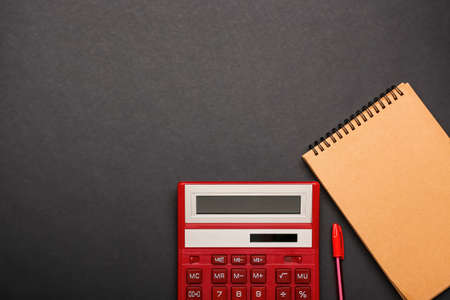 Modern calculator and stationery on dark backgroundの写真素材