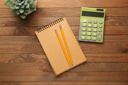 Modern calculator and stationery on wooden backgroundの写真素材
