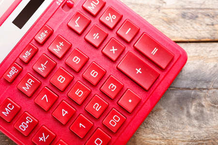 Modern calculator on wooden background, closeup