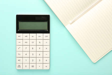 Modern calculator and notebook on color backgroundの写真素材