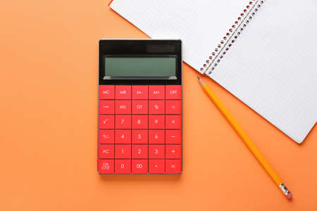 Modern calculator and stationery on color backgroundの写真素材