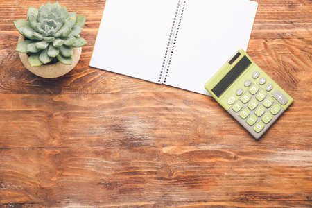 Modern calculator and stationery on wooden backgroundの写真素材