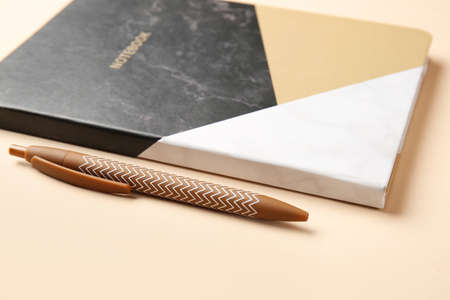 Notebook and pen on color backgroundの写真素材