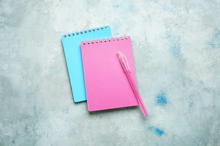 Notebooks and pen on color backgroundの写真素材