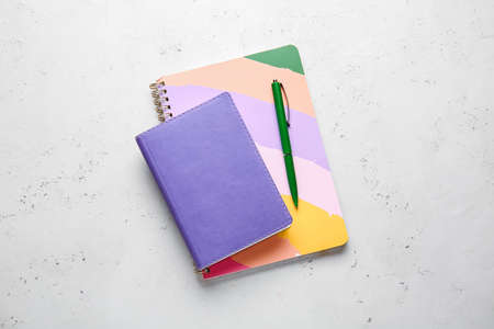 Notebooks and pen on light backgroundの写真素材