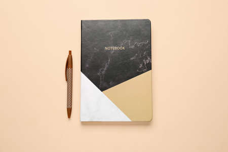 Notebook and pen on color backgroundの写真素材