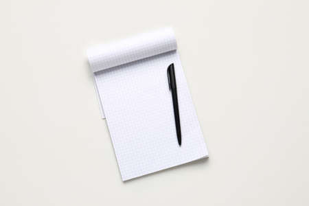 Notebook and pen on white background