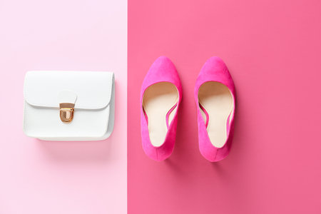 Stylish female shoes and bag on color backgroundの写真素材