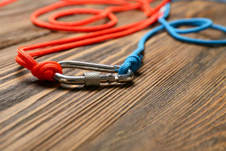 Ropes with lobster clasp on wooden background