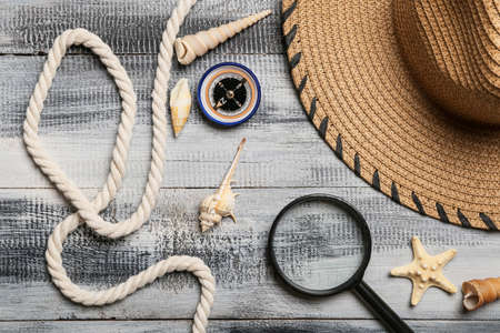 Set of travel items with rope on wooden backgroundの写真素材