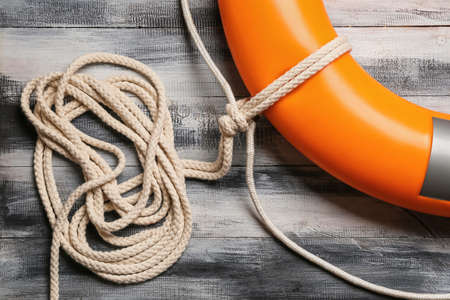 Rope and lifebuoy on wooden backgroundの写真素材